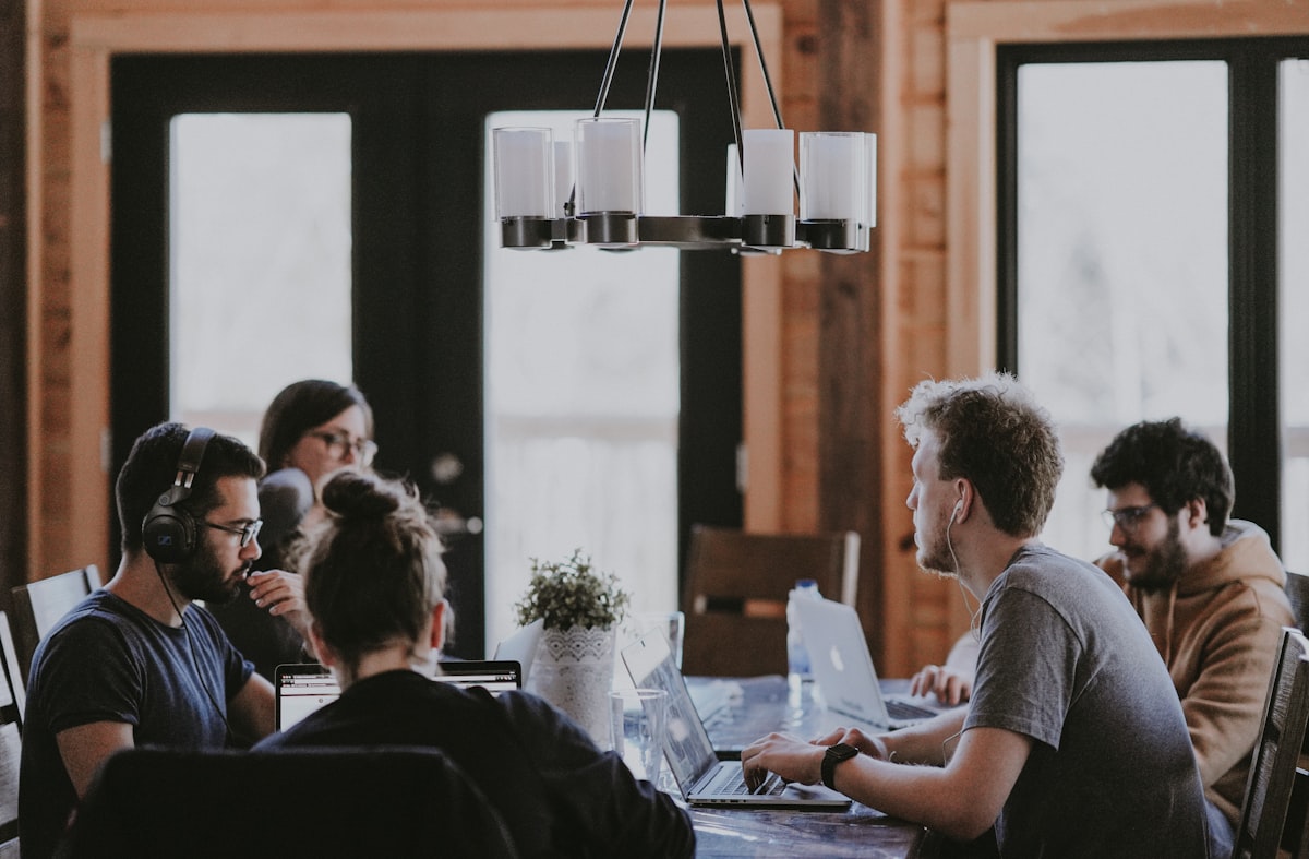 Colleagues working together around a studio table