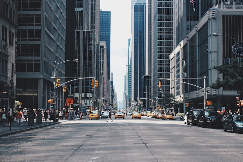 A city avenue seen between towers at first light
